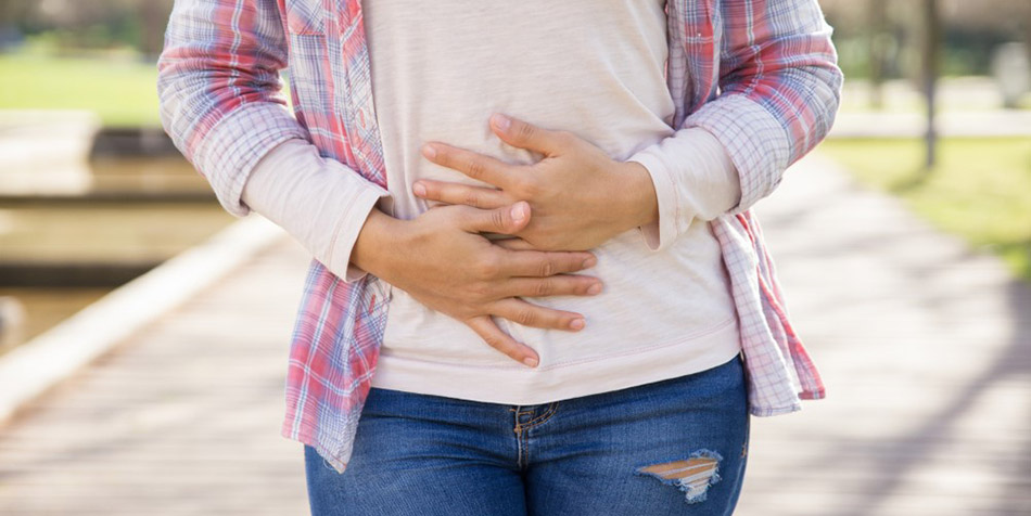 A woman practices diaphragmatic breathing exercises.